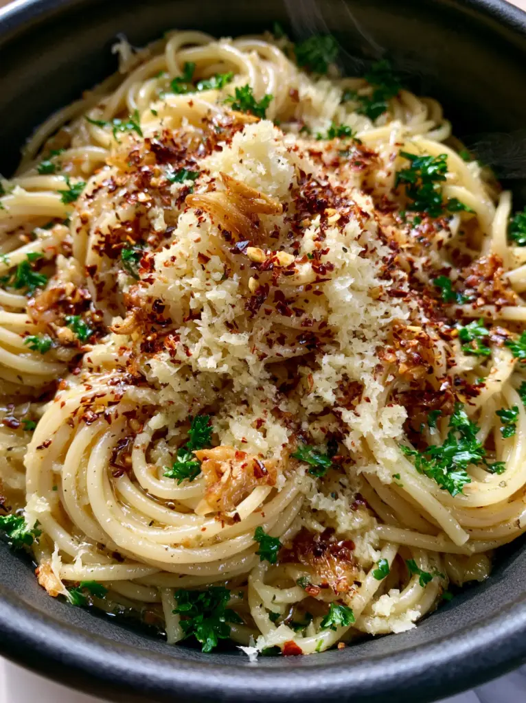 A macro shot showing the texture of the fluffy microplaned parmesan on Garlic butter pasta.