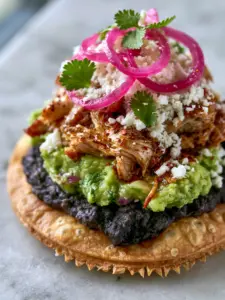 Extreme macro close-up of the jagged, bubbly edge of a golden fried corn tortilla for chicken guacamole and bean tostadas. (chicken guacamole and bean tostadas)