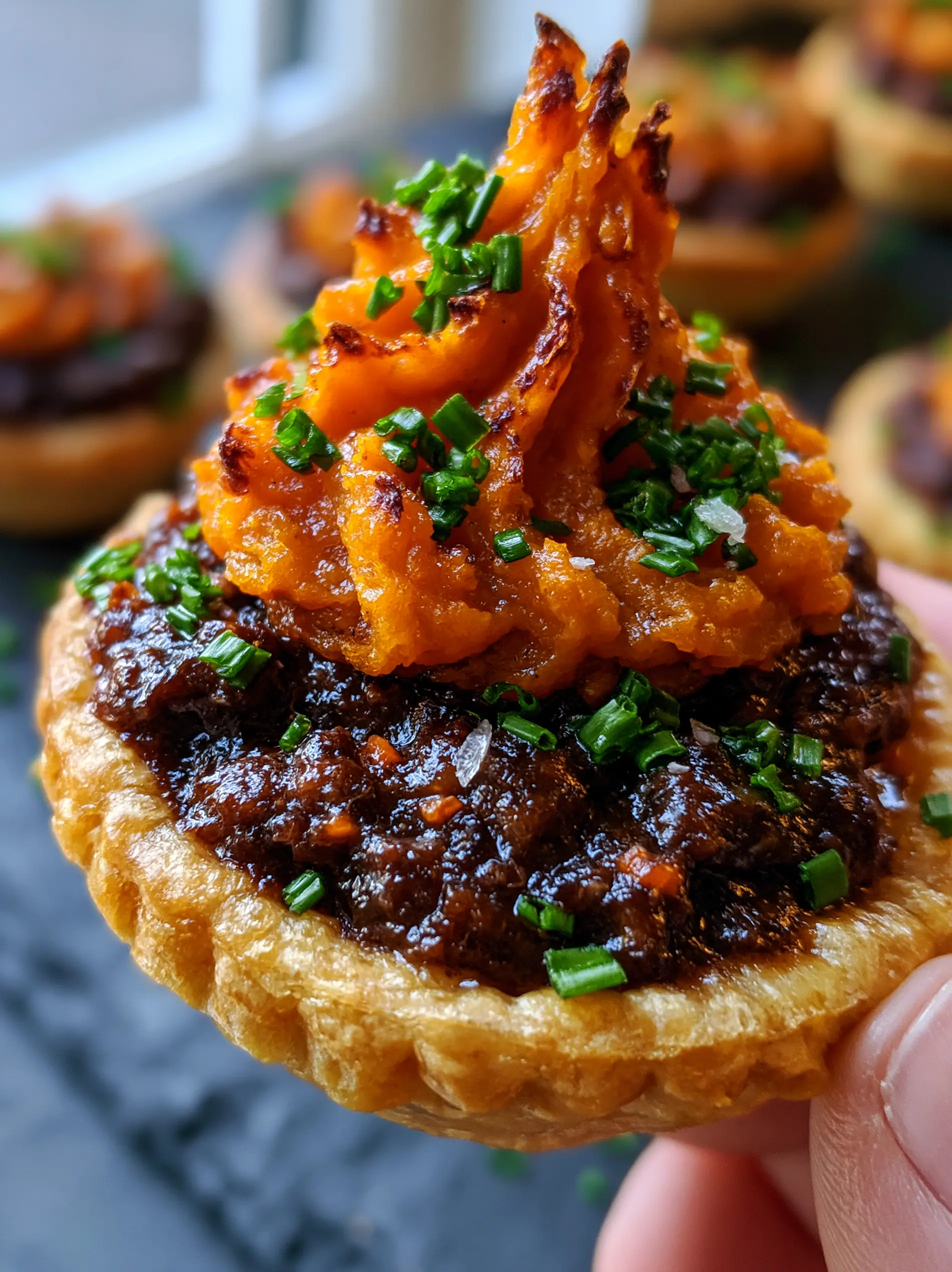 Close-up of the thick glossy gravy and minced carrots inside the Irish beef sweet potato mini pies. (Irish beef sweet potato mini pies)